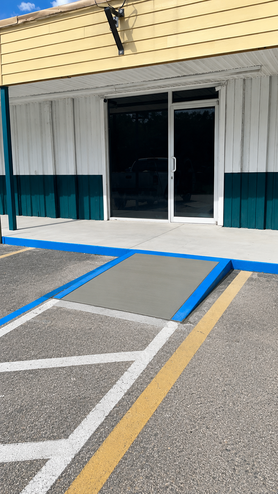 ADA compliant concrete ramp at commercial storefront