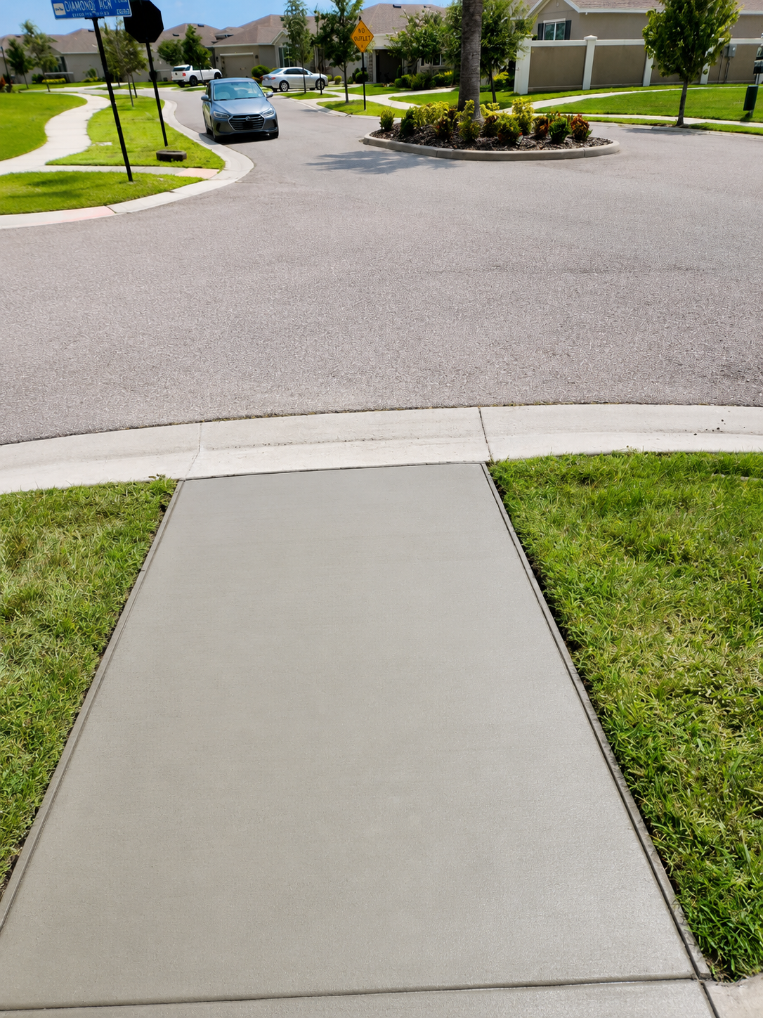 New concrete driveway apron and sidewalk panel in residential neighborhood